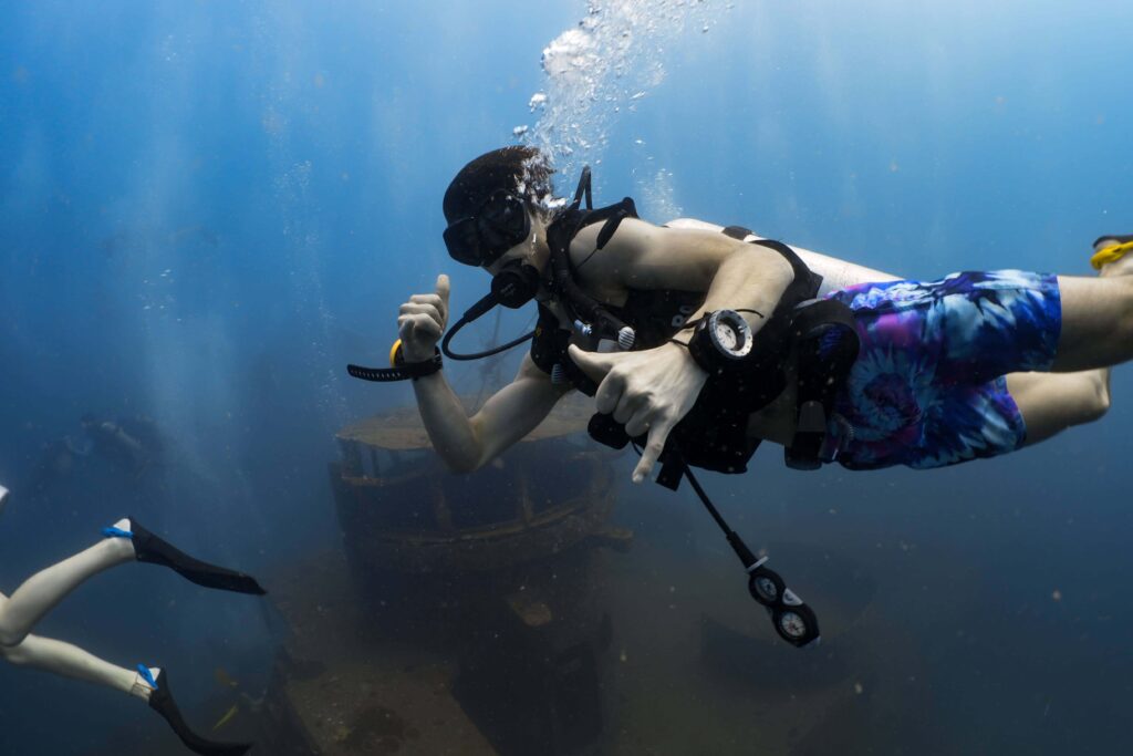 scuba diver giving hand signals