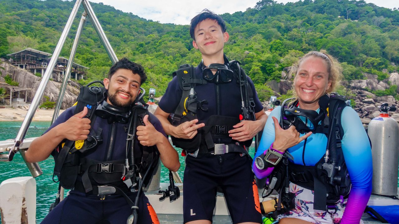 Female divemaster leading a dive group