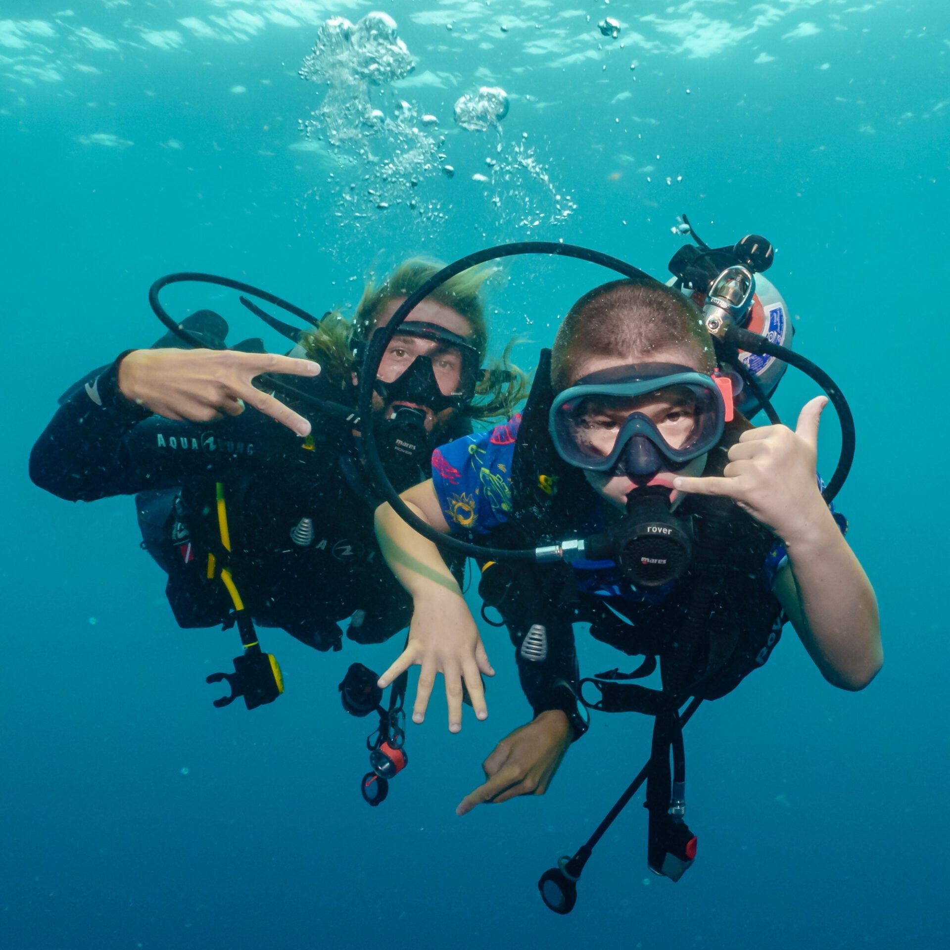 Two young divers underwater together in Koh Tao