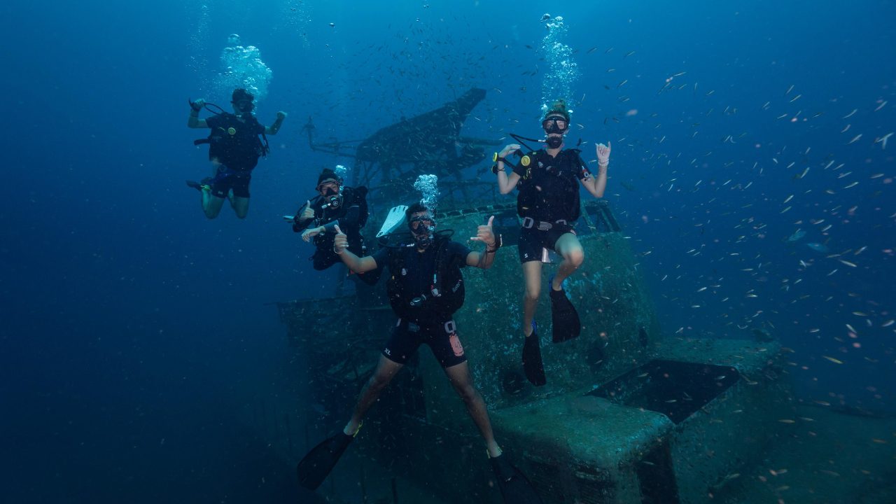 Professional divemaster leading deep dive expedition