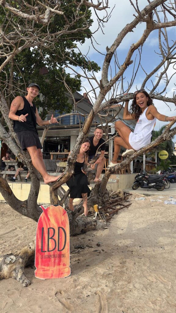 Celebrating open water next to a tree