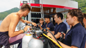 Dive instructor briefing a small group of scuba divers