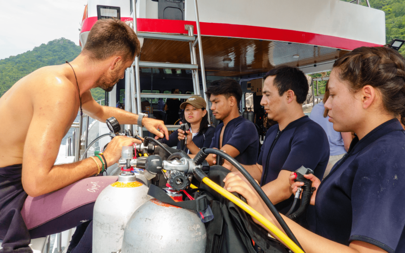 Dive instructor briefing a small group of scuba divers
